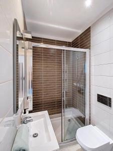a bathroom with a shower and a sink and a toilet at Panorama Old Town sea view Albufeira in Albufeira