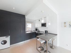 a kitchen with a table and a washing machine at Panorama Old Town sea view Albufeira in Albufeira +14 photos