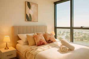 a bedroom with a bed with a large window at Botanic Serenity - QWR Lv 49 Luxury | BNE River in Brisbane