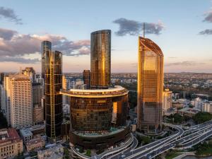 a group of tall buildings in a city at Botanic Serenity - QWR Lv 49 Luxury | BNE River in Brisbane