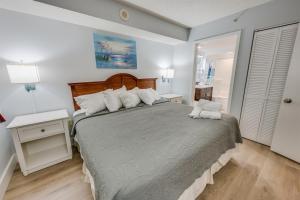 a bedroom with a bed with two pillows on it at Roxanne Towers Remodeled with Amazing Views,Pools! in Myrtle Beach +46 photos