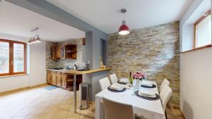 a kitchen and dining room with a table and chairs at au pied du Haut Koenigsbourg 1 in Saint-Hippolyte +24 photos