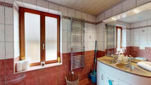 a bathroom with a sink and a mirror at au pied du Haut Koenigsbourg 1 in Saint-Hippolyte