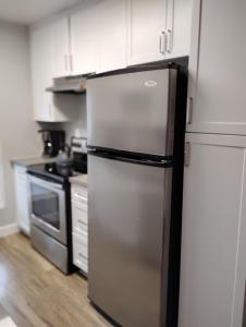 a kitchen with a refrigerator and a stove at Cozy 2bdr Beach home in Huntington Beach +4 photos