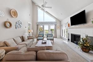 a living room with a couch and a fireplace at RD2224: 2224 Rolling Dune in Seabrook Island