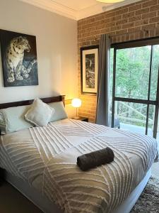 KurrajongMountain View Blue Mountains的一间卧室，里面有一张床和一扇大窗户。