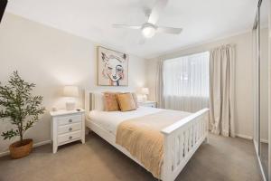 una camera da letto bianca con un letto bianco e una finestra di Brighton Escape Seaside Living near Dining and Jetty a Brighton