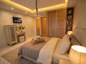 a bedroom with a large bed and a table at Villa Lumiere-Luxury Retreat with Private Spa and Garden in Ifrane