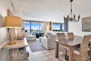 a living room with a table and a dining room at Wind Drift 313N in Orange Beach