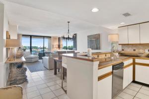 a kitchen with white cabinets and a living room at Wind Drift 313N in Orange Beach