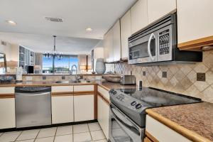 a kitchen with a stove and a microwave at Wind Drift 313N in Orange Beach +25 photos