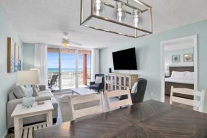 a living room with a couch and a dining room table at Buena Vista 102 in Gulf Shores