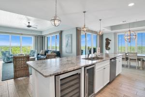 a kitchen and living room with a large counter top at The Wharf 701 in Orange Beach
