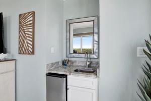 a kitchen with a sink and a mirror at The Wharf 701 in Orange Beach