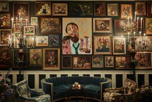 a living room with a large painting on the wall at Pontchartrain Hotel St. Charles Avenue in New Orleans