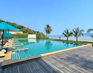 a swimming pool with a view of the ocean at Panoramic sea view flat, overlooking Bang Bao in Ban Bang Bao