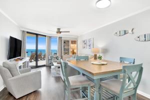 a dining room and living room with a table and chairs at Phoenix III 3038 in Orange Beach