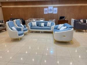 four blue and white couches in a waiting room at Gambie in Kaolack +4 photos