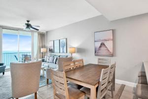 a dining room with a table and a couch at Lighthouse 1713 in Gulf Shores