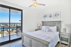 a bedroom with a bed and a balcony at Phoenix X 1201 in Perdido Key +36 photos