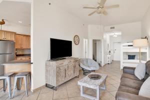 a living room with a flat screen tv and a couch at Phoenix V 014 in Orange Beach