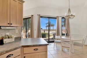 a kitchen and dining room with a table and chairs at Phoenix V 014 in Orange Beach