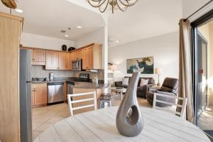 a kitchen and living room with a table with a vase on it at Phoenix V 014 in Orange Beach