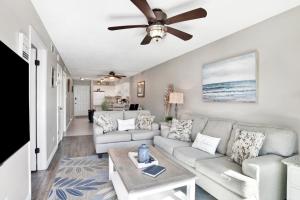 a living room with a couch and a ceiling fan at Lei Lani M119 in Orange Beach