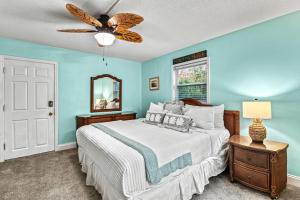 a bedroom with a bed and a ceiling fan at Plumbago - 5251C in Siesta Key +52 photos