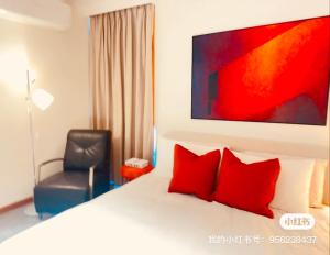a bedroom with a bed with red pillows and a chair at Stylish 2BR Family-Friendly Retreat 4Guests Doncaster Westfield in Doncaster