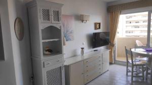 a kitchen with a white cabinet and a dining room at Relax Beach in Benalmádena