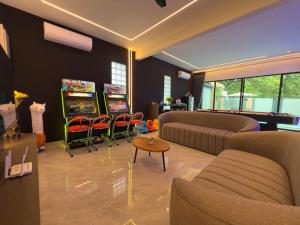 a living room with a couch and a table and chairs at LYL 108 Private Pool Villa in Ipoh
