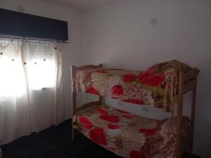 a bedroom with two bunk beds and a window at Descanso LA MARTA in Pueblo Esther