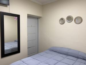 a bedroom with a bed and a mirror at Shanti Loft B in San Juan