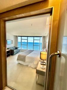 a bedroom with a bed and a view of the ocean at Hotel Nacional in Rio de Janeiro +41 photos
