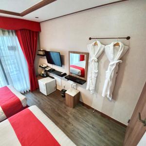 a hotel room with a bed and a television at CS Premier Hotel in Anyang +57 photos