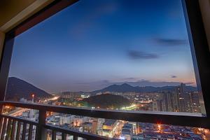 a view from a balcony of a city at night at CS Premier Hotel in Anyang