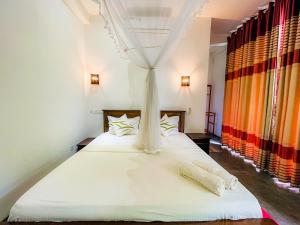 Una cama o camas en una habitación de Sunworld Villa