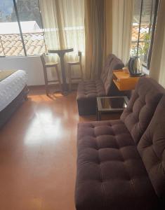 a living room with a couch and a table at Hotel Boutique MIRANDO AL SOL in Ollantaytambo