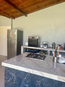 a kitchen with a stainless steel refrigerator and a counter at Cantinho Aconchegante in Macapá