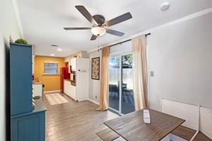 a living room with a ceiling fan and a table at 5 min to AT&T Stadium, Game Room, Huge Yard in Arlington