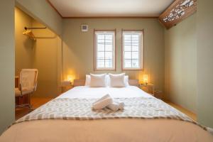 a bedroom with a bed with a teddy bear on it at Villa El Sendero Sapporo in Sapporo