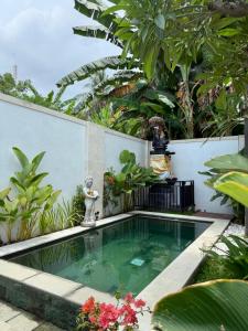 a small swimming pool in a garden with plants at Villa Dylia with private pool in Panji