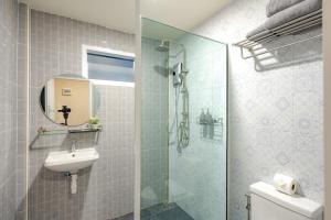 a bathroom with a shower and a sink and a toilet at Treerat Bangtao House in Ban Hua Phrong