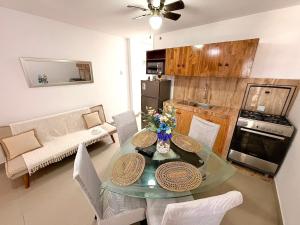 a living room with a glass table and a couch at Comfortable House in Punta Hermosa