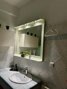 a bathroom with a sink and a mirror at Tzelak Village House in Palaiomonástiron +16 photos