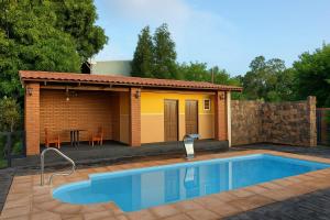 a small house with a swimming pool in front of it at DON MIGUEL DEPARTAMENTOS in Puerto Iguazú