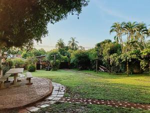 a park with a bench in the middle of a field at DON MIGUEL DEPARTAMENTOS in Puerto Iguazú