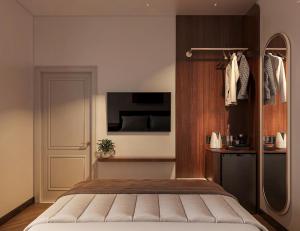 Schlafzimmer mit einem Bett, einem TV und einer Tür in der Unterkunft Chingu Boutique 2 in Vũng Tàu