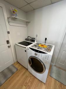 a washer and dryer in a small room at Cozy Escape in the City in Port Coquitlam +6 photos